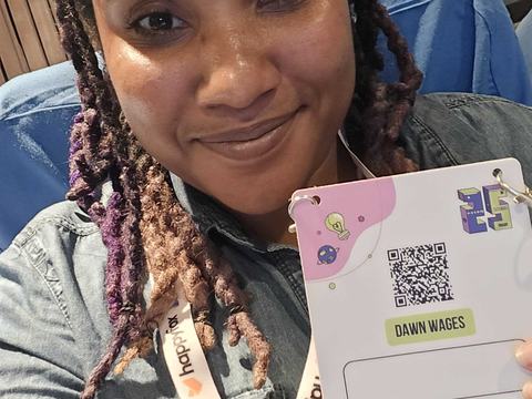 Me at the conference with my badge.