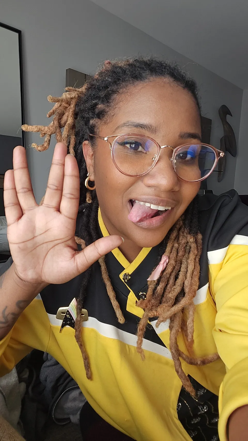 Me in a yellow Starfleet uniform, giving the Vulcan salute