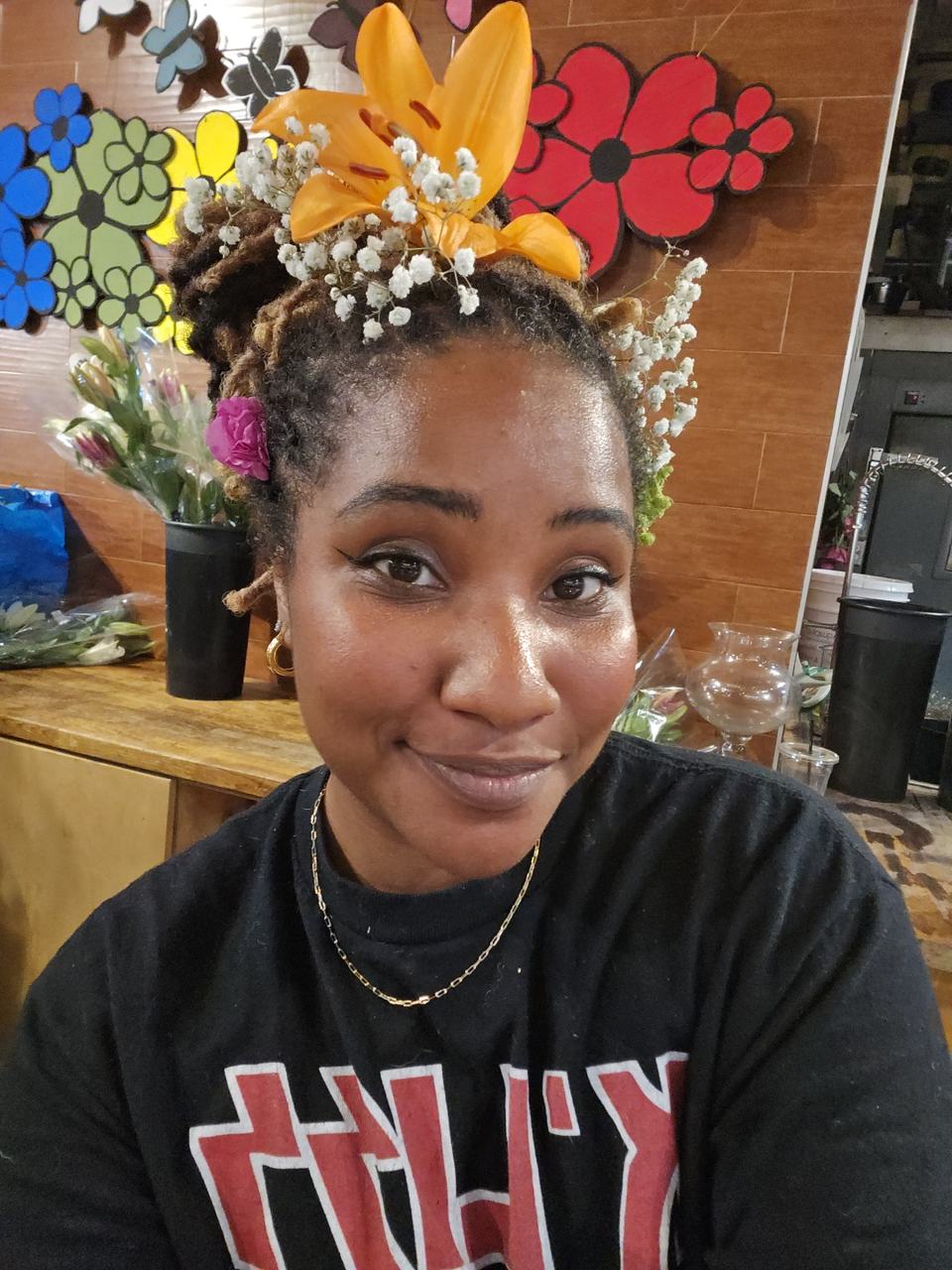 Me at the flower shop with an orange lily and baby's breath tucked into my hair